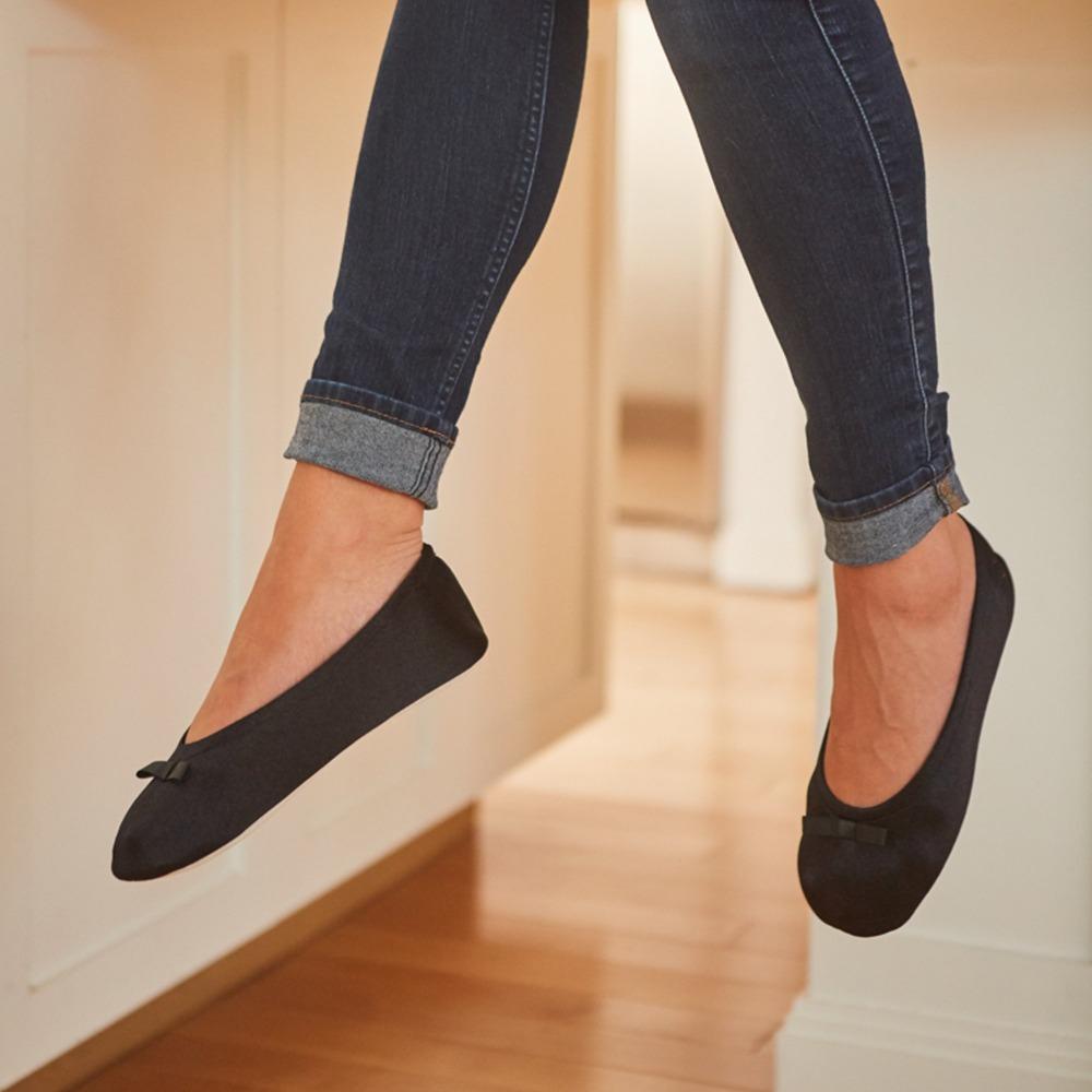 Model wearing Satin Ballerina in Black sitting on stool in kitchen