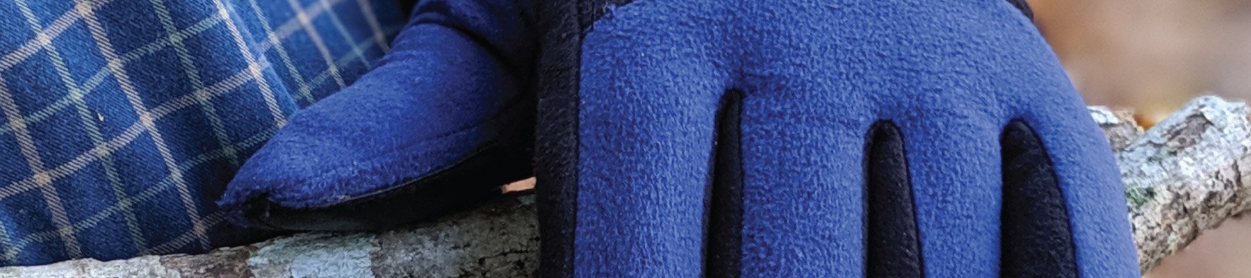 Men's Pieced Glove in navy holding wood