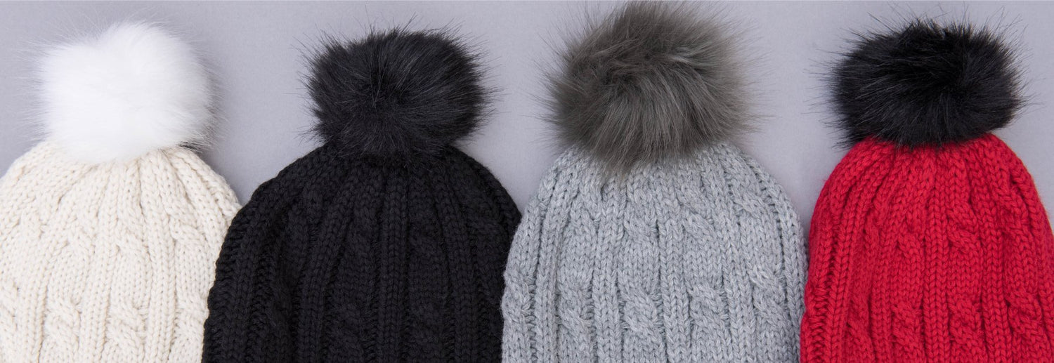 Women’s Chunky Cable Knit Flip-Top Mittens on model outside against fence