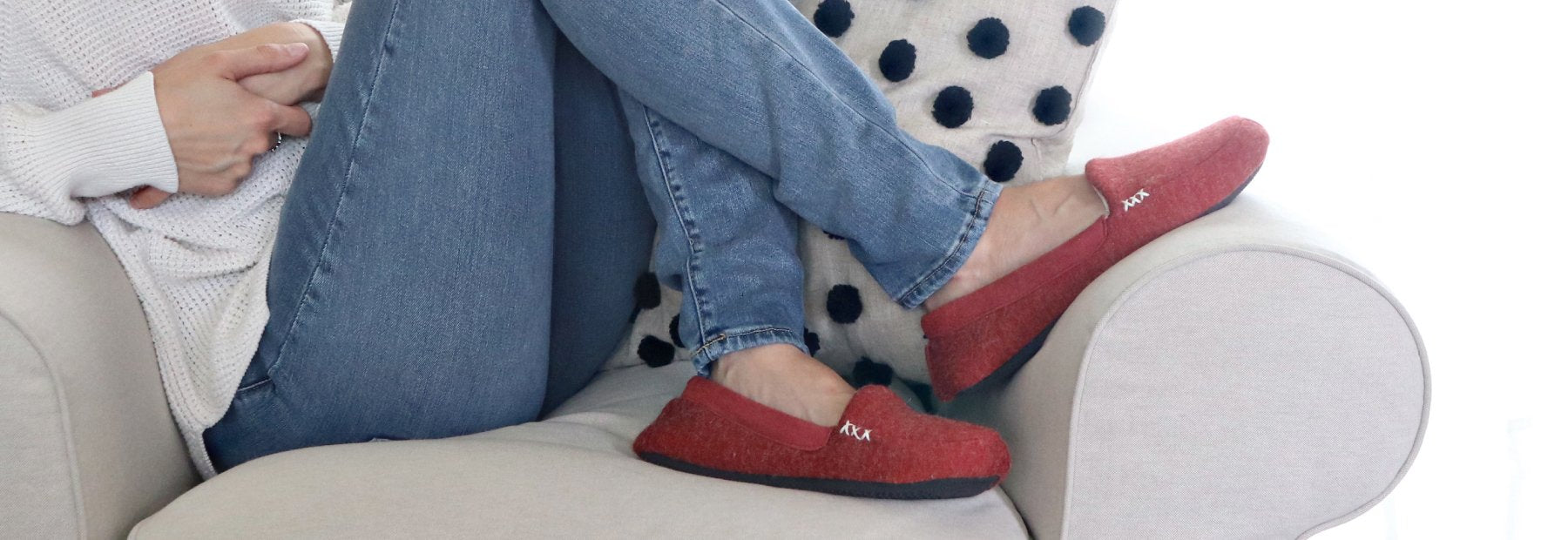 Women’s Marisol Microsuede Moccasin Slippers on foot sitting on cozy couch