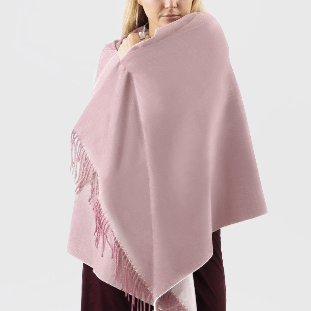 Women’s Recycled Scarf with Fringe in Winter Blossom Pink on model. Wrapped around model's shoulders like a Blanket. Front View