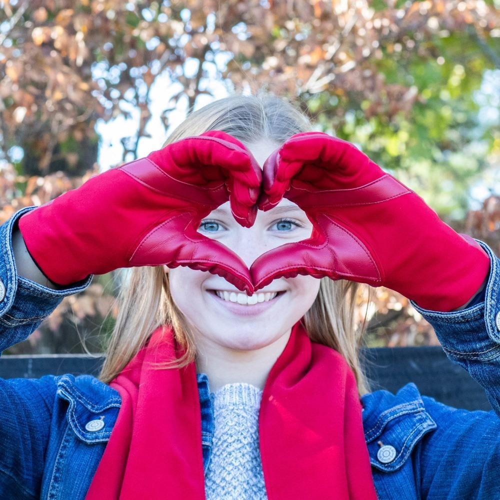 Women's Stretch Leather Gloves in Really Red on Model Making a Heart with her hands