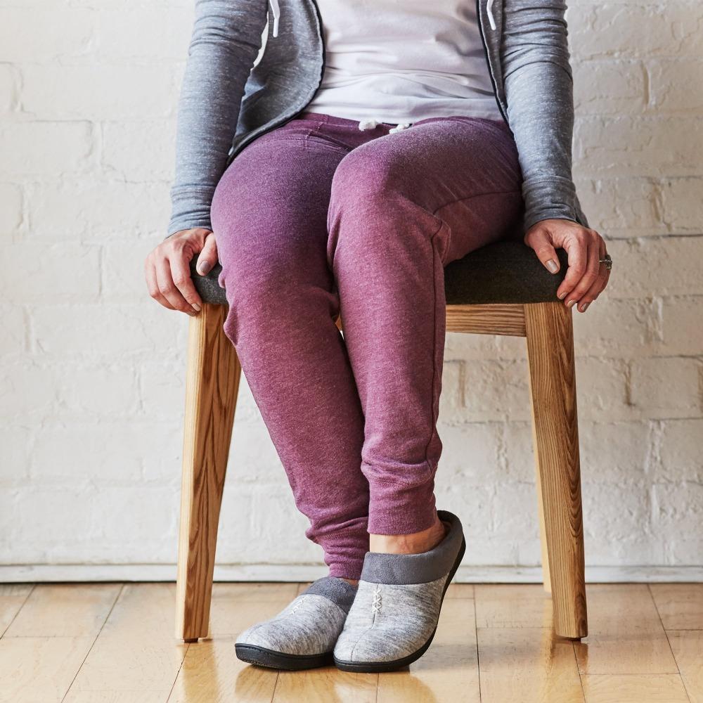 Women's Marisol Microsuede Knit Hoodback Slippers in Heather Grey on Model seating in chair
