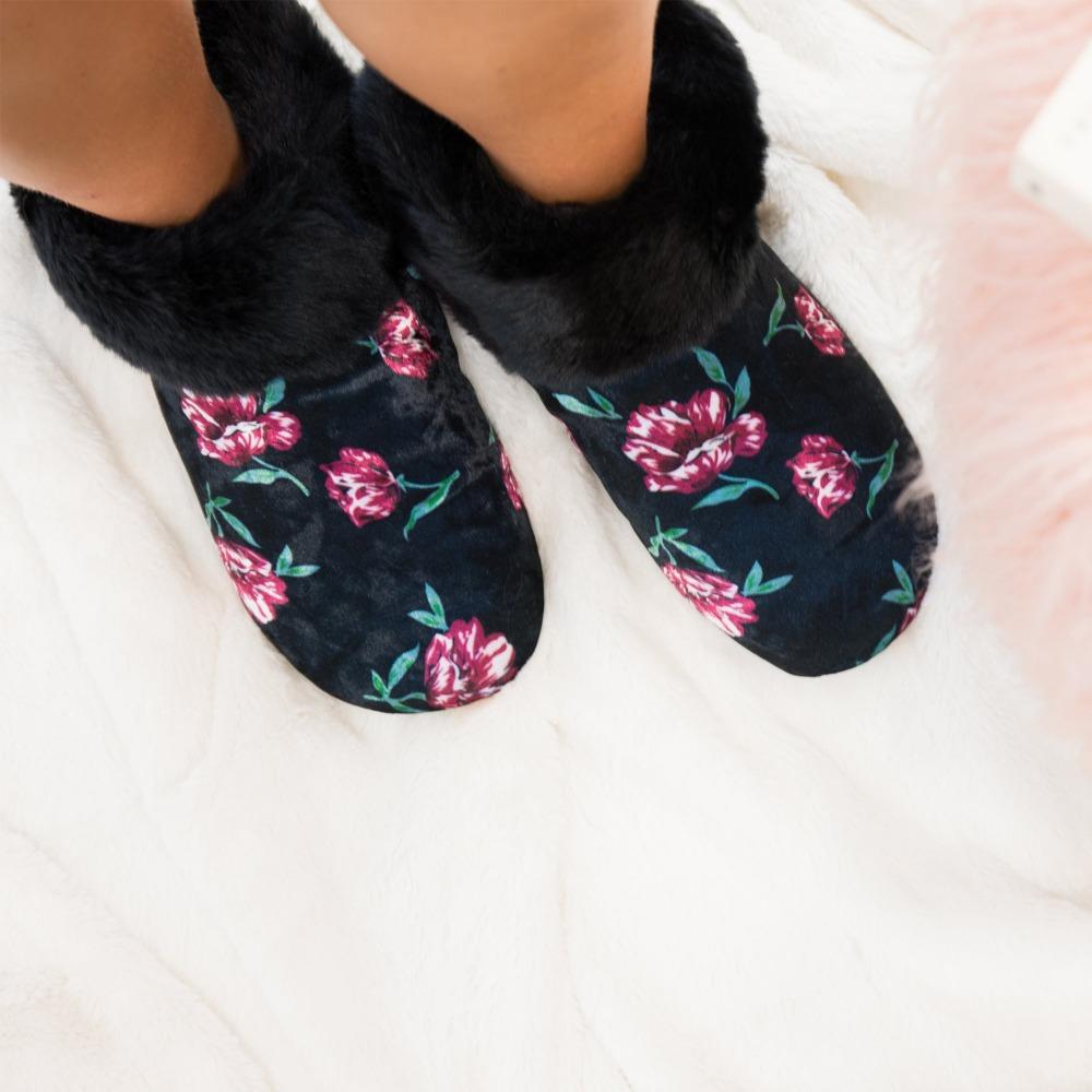 Women's Stretch Velour Sabrine Bootie Slippers in Floral on Model standing on white fluffy rug