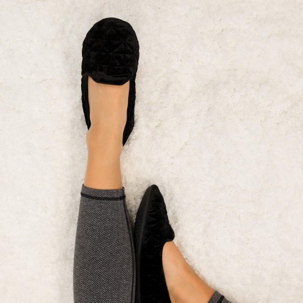 Women's Stephanie Crushed Velour Closed Back Slippers in Black on Model Laying on Fur Rug