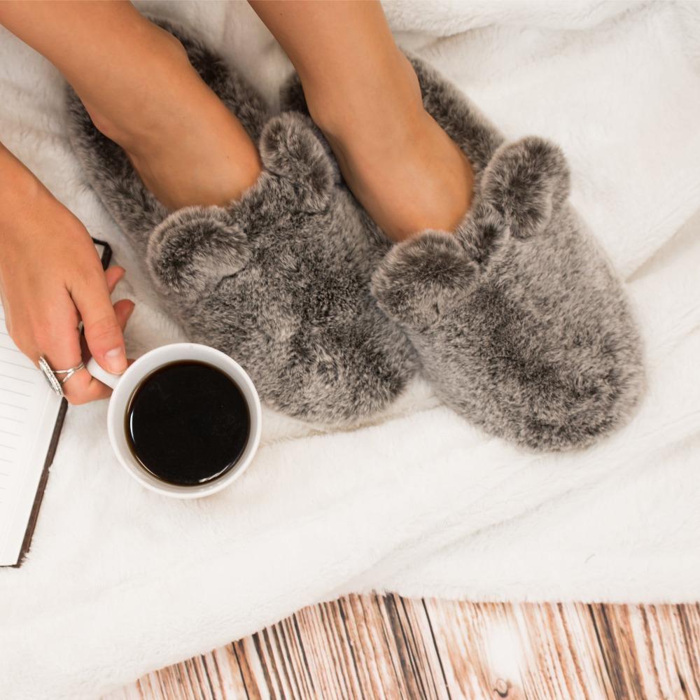 Women's Faux Fur Fey Novelty Hoodback Slippers in Dark Chocolate Bear on Model on Fur Rug with Coffee Mug