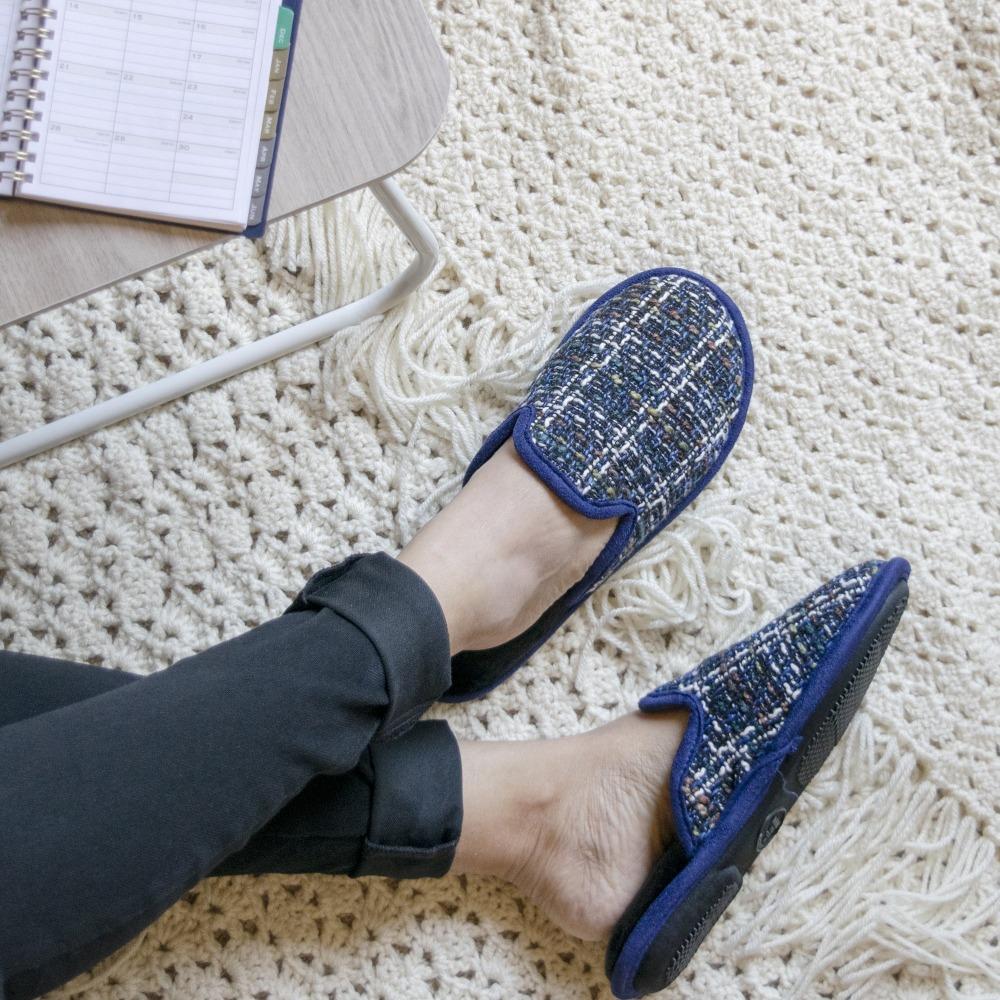 Women's Tweed Kaitlyn Scuff Slippers in Steele Blue on model sitting down on a quilted blanket filling in a day planner
