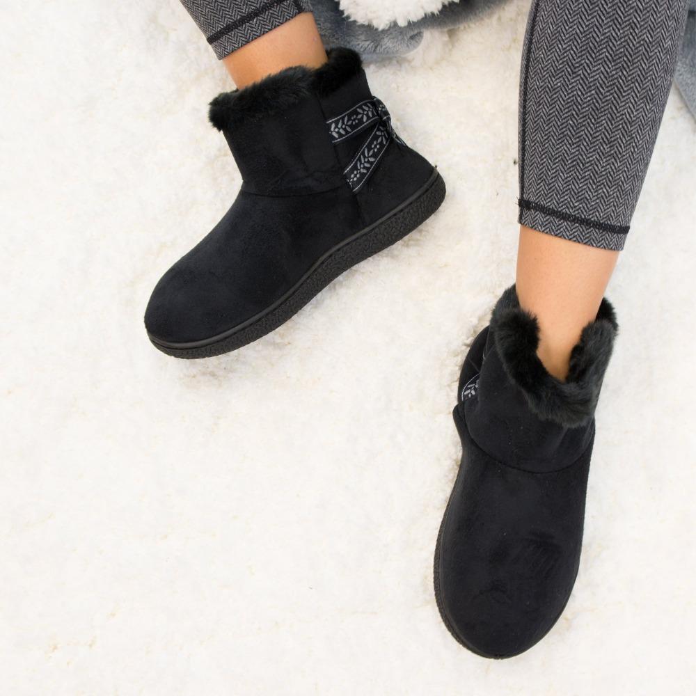 Women's Microsuede Addie Boot Slippers with Bow in Black on model on plush fur rug