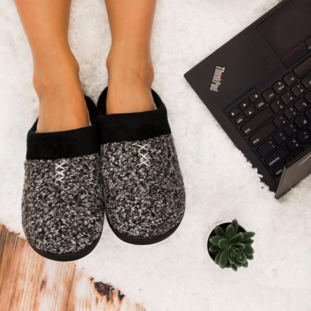 Women's Heathered Knit Jessie Hoodback Slippers in Dark Charcoal Heather on Model working on a laptop on a white fur rug