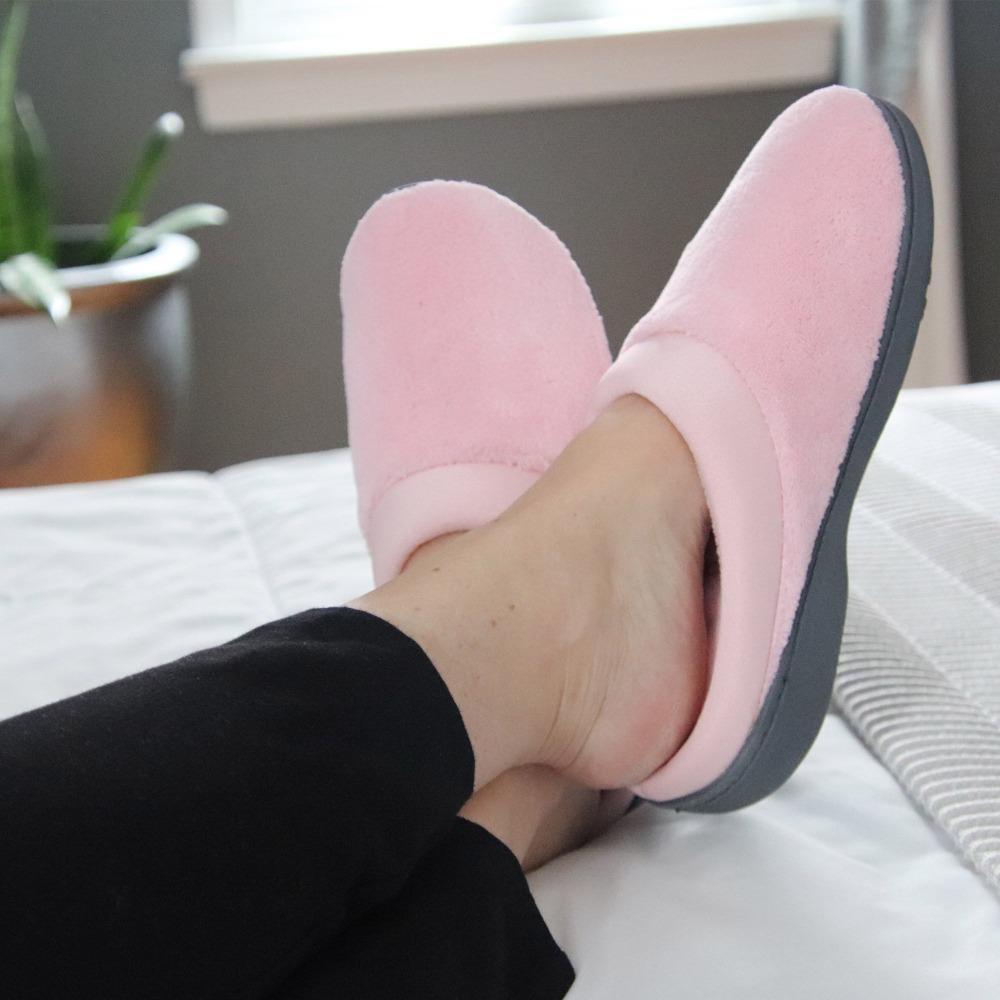 Signature Women's Matte Satin Hoodback Slippers in Petal Pink On Model Laying on Bed