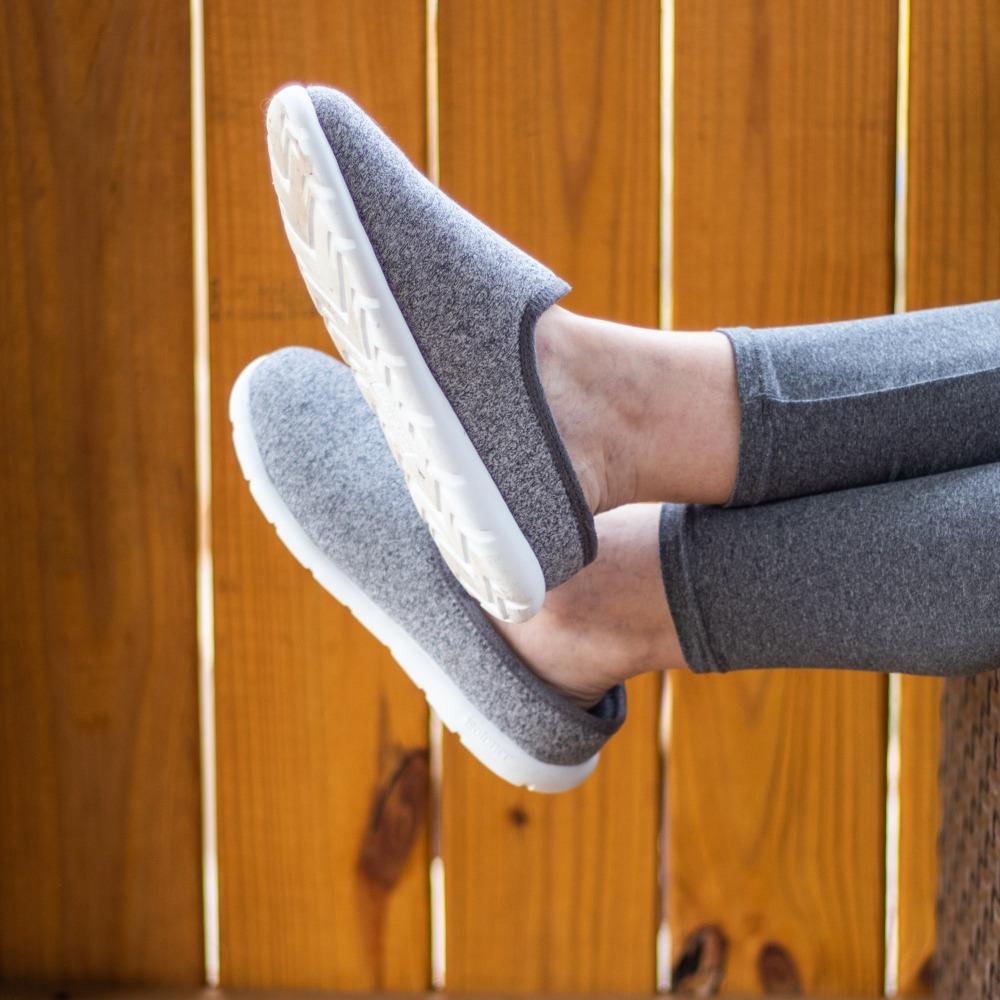 Model wearing Women's Energize Zenz SLip ons kicking her feet up