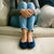 Women's Classic Terry Ballerina Slippers on model sitting on couch