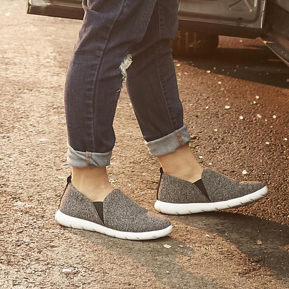 Woman wearing Black heather Zenz Tranquility slip ons getting into a car