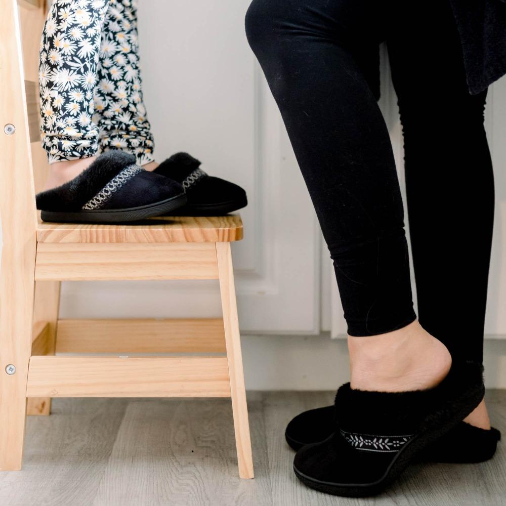 Isotoner Kids Wendi Slipper standing on stool with mom in kitchen wearing matching slippers