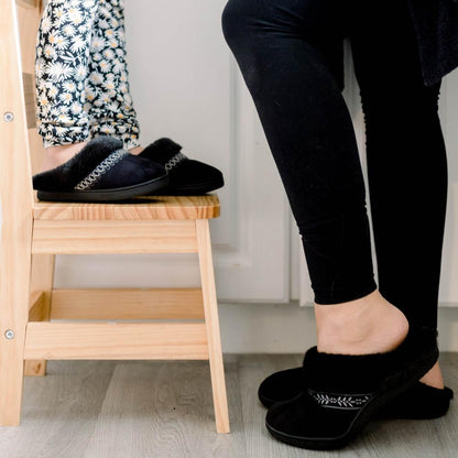 Isotoner Kids Wendi Slipper standing on stool with mom in kitchen wearing matching slippers